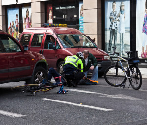 First responders help injured cyclist. 