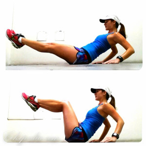Women demonstrates v-sit exercise.